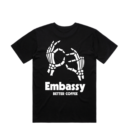 Black t-shirt with white graphic design and 'Embassy Better Coffee' text on a white background